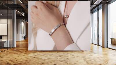 Woman wearing elegant pendant necklace and bracelet on close-up Wall mural