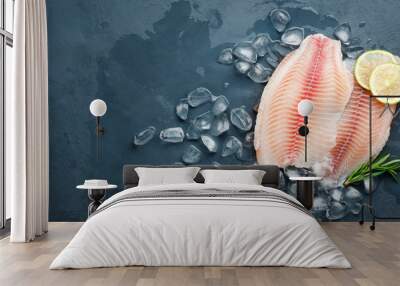 Fresh fish fillet of sea bass in ice on a dark slate background. Top view. Copy space for text. Wall mural