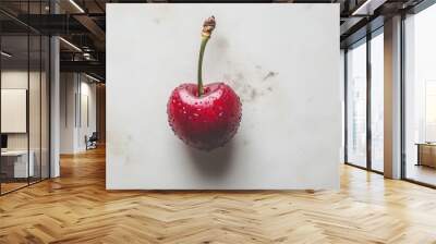 Fresh red cherry with water droplets resting on a marble countertop in natural light Wall mural