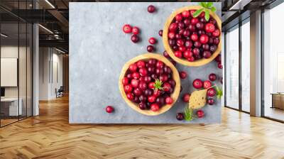 Fresh red cranberry in wooden bowl. Autumn harvest of wild berries. Above view. Wall mural