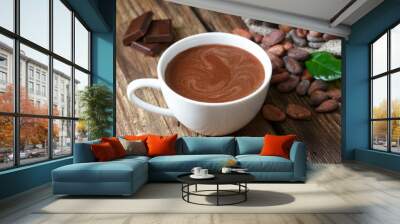 Hot chocolate in the cup on the wooden table. Wall mural