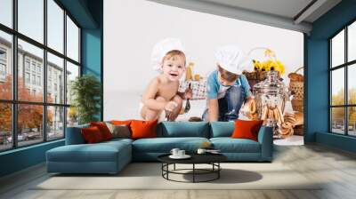 Little girl and funny boy wearing chef hats  Wall mural