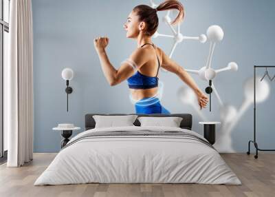 Sporty young woman runing and jumping. Wall mural