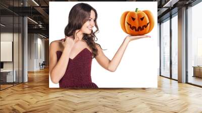 Young woman holding carved pumpkin. Wall mural