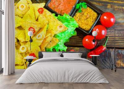 Nachos top view with Tortilla chips tomato salsa and mustard on rustic wooden background. A textured background.Copy paste place Wall mural