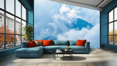 Heavy fog in the mountains on a cloudy day. High mountain with green slopes hidden in clouds and fog. Wall mural