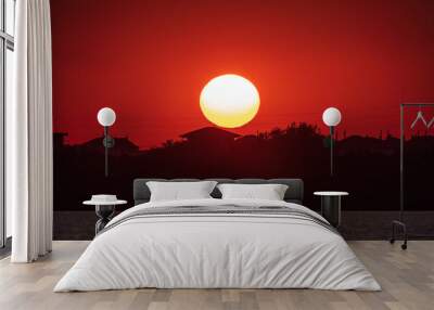 The sun goes down over a lake Wall mural