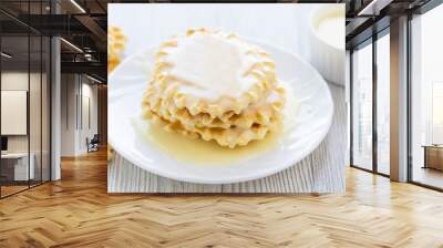 Sweet Condensed or evaporated milk and waffles on a table. A delicious Breakfast. Wall mural