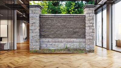 The texture of a stone fence with rectangular blocks and concrete seams. Wall mural