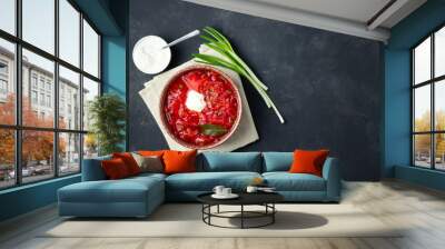 Vegetarian beet red soup - borscht with sour cream on black stone background. Top view. Wall mural