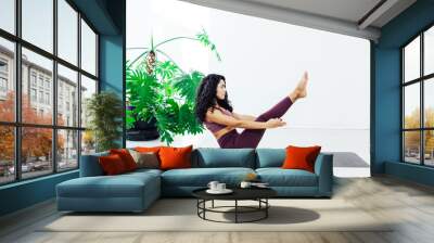 Beautiful woman yoga asana engaged in fitness gym Wall mural