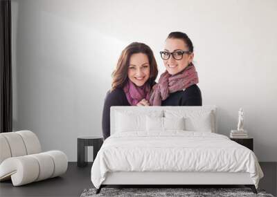 two girls cuddling a laughing glasses Wall mural