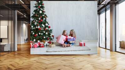 two girls opens Christmas presents new year Christmas tree Garland lights Wall mural