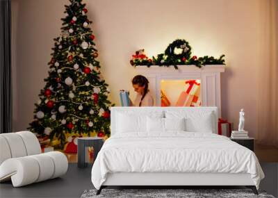 woman decorates a Christmas tree new year gifts Garland lights Wall mural