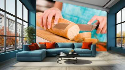 Woman cutting bread on the kitchen Wall mural