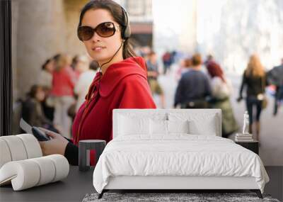 young woman with headphones, listening to audio guide Wall mural