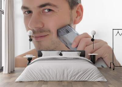 Young handsome male shaving face beard . isolated on white backg Wall mural