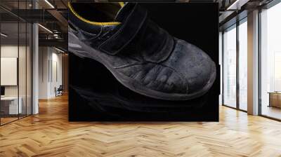 old working boots on black background Wall mural