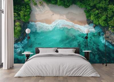 A beautiful blue ocean with a sandy beach and trees in the background Wall mural