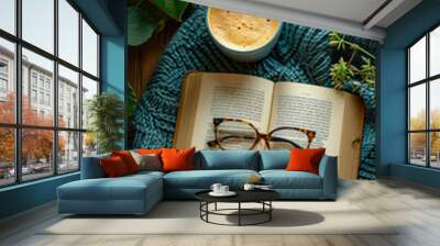 a book and a mug of coffee are on a table Wall mural