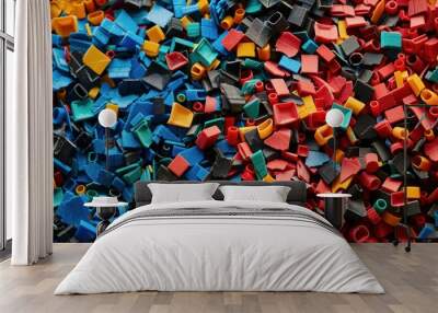 A pile of colorful plastic pieces with a mix of black and red Wall mural