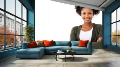 A young woman with natural hair smiles while standing with arms crossed, showcasing her casual style Wall mural