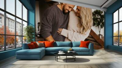 Beautiful loving couple hugging each other and kissing, natural light and authentic emotion Wall mural