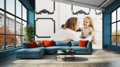 Young mother with a beautiful daughter Wall mural