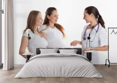 two pregnant women and doctor.. Wall mural