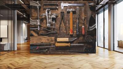 Old carpentry work tools on a brown wooden table background. Wall mural