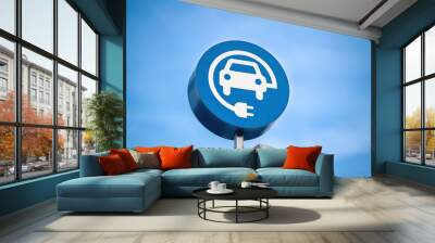 electric vehicle charging sign, blue sky background Wall mural