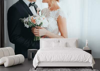 beautiful bride and groom posing at the hotel Wall mural