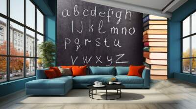 Alphabet on a chalkboard with books Wall mural