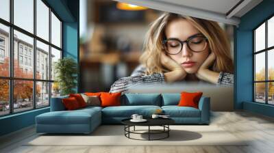 tired beautiful girl with glasses fell asleep at her laptop from fatigue, headache from depression Wall mural