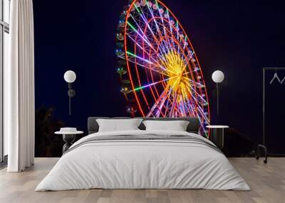 Large ferris wheel in Batumi shining with many colors at night Wall mural