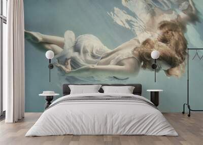 A girl in an airy light dress swims underwater as if flying in zero gravity Wall mural