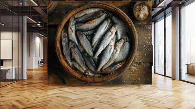 A rustic wooden basket filled with fresh fish glistens in natural light, resting on an aged wooden table, showcasing a time-honored fishing tradition Wall mural