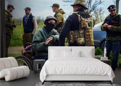 Disabled man in a wheelchair with a group of soldiers Wall mural