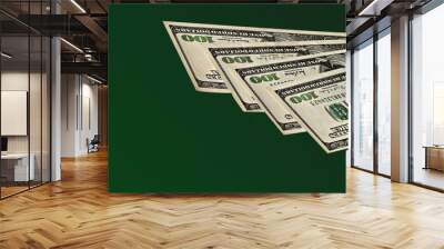 Hundred dollar banknotes isolated on green background Wall mural