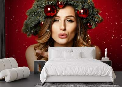 Beautiful woman with Christmas spruce fir wreath with cones and new year decoration red balls Wall mural