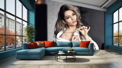 Beautiful young woman with bottle of perfume at home Wall mural