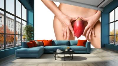 Body care gynecology close up photo of woman hand red mango fruit near Intimate part of her abdomen Wall mural