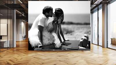 Couple kissing hugging walking on a road together hold hands. Romantic vacation, honeymoon love story Wall mural