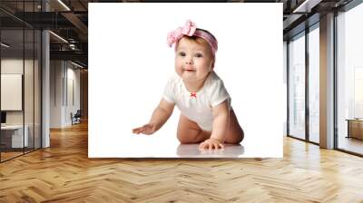 Curios much surprised adorable infant baby girl in white body and hair bow decoration creeps on floor looking at camera Wall mural