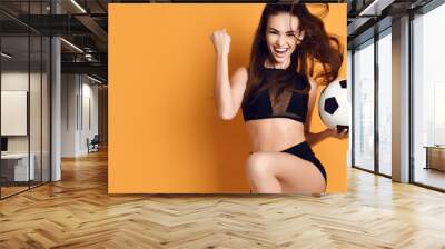 Fan sport woman player in black uniform hold soccer ball celebrating happy up with free text copy space Wall mural