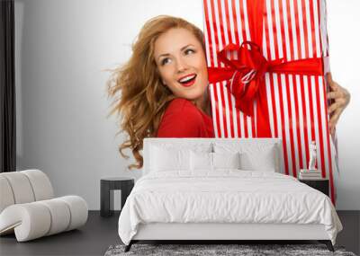 Happy young woman hold red Christmas wrapped gift present smilin Wall mural