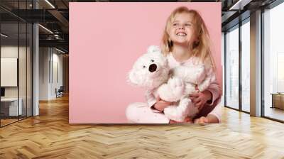 Little baby girl toddler sitting  with white polar teddy bear happy smiling on pink  Wall mural