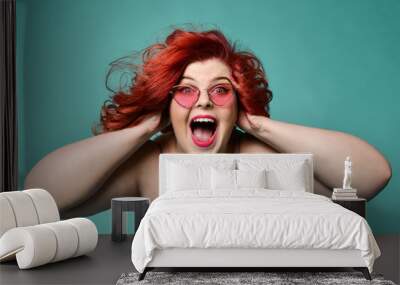 Shouting laughing loud overweight fat woman holds her head with hands can't believe huge discount sale or crazy luck Wall mural