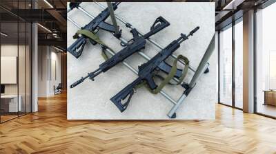 Machine guns lie on a metal stand. Firearms for fighting. View from above. Close-up Wall mural