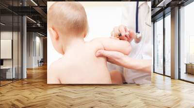 Close-up shot of pediatrician ready to give an intramuscular injection of a vaccine to a baby girl Wall mural